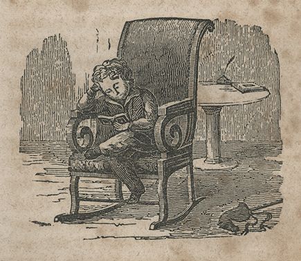 a boy sits in a chair and reads a book